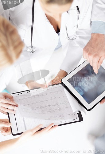 Image of group of doctors looking at x-ray on tablet pc