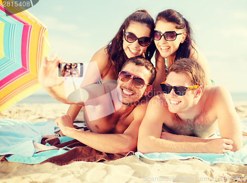 Image of group of people taking picture with smartphone