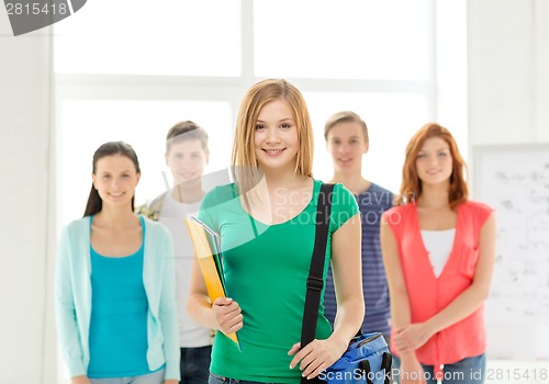 Image of smiling students with teenage girl in front