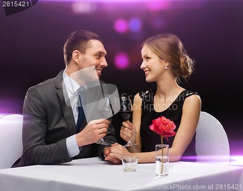 Image of young couple with glasses of wine at restaurant
