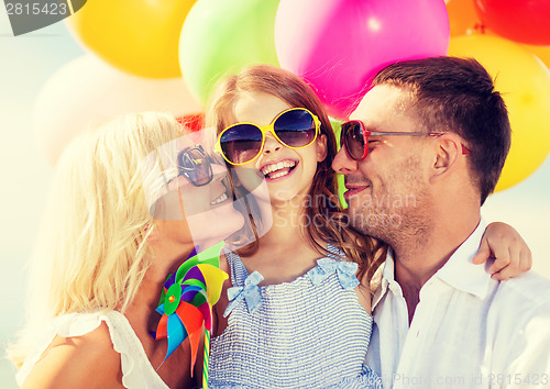 Image of family with colorful balloons