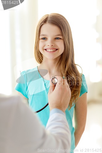 Image of male doctor with stethoscope listening to child