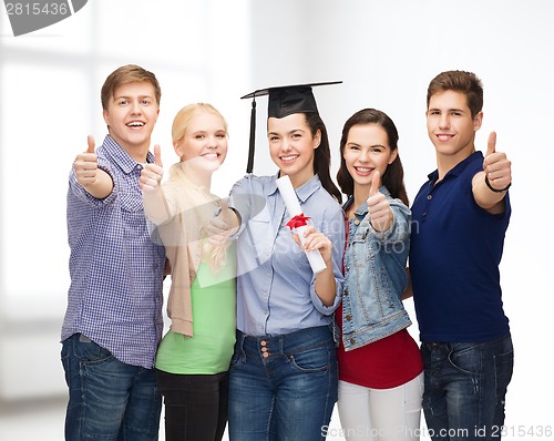 Image of group of students with diploma showing thumbs up