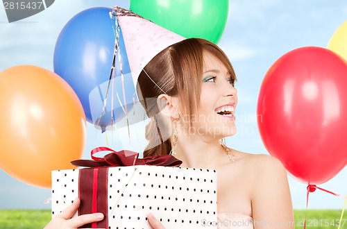 Image of party girl with balloons and gift box