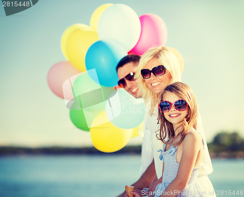 Image of family with colorful balloons