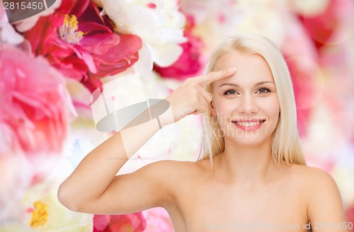 Image of beautiful woman touching her forehead