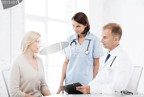 Image of doctor and nurse with patient in hospital