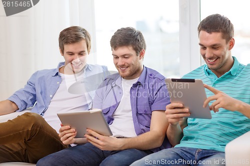 Image of smiling friends with tablet pc computers at home