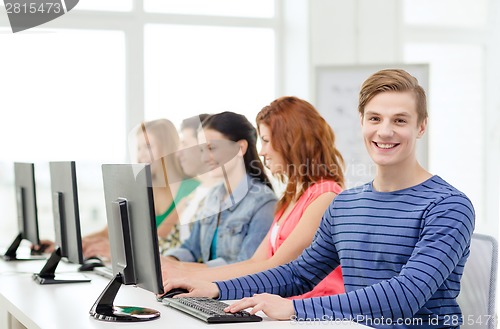 Image of male student with classmates in computer class