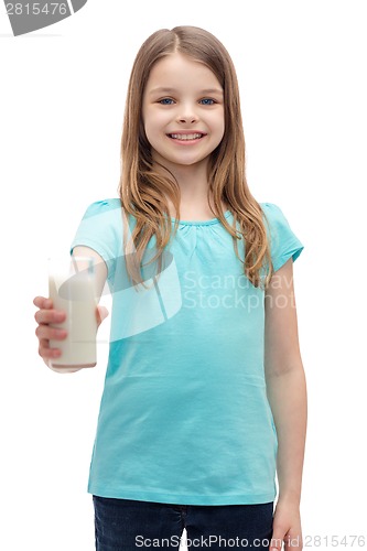 Image of smiling little girl giving glass of milk
