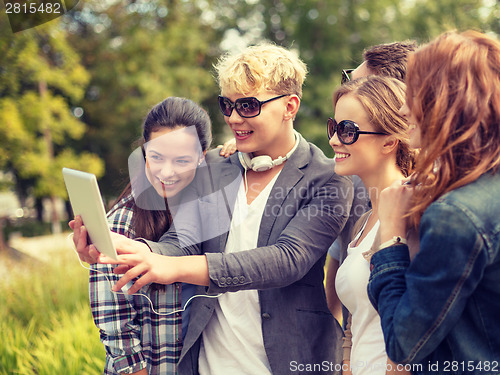 Image of teenagers taking photo with tablet pc outside