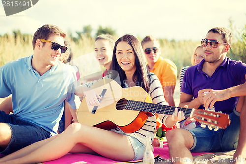 Image of group of friends having fun on the beach