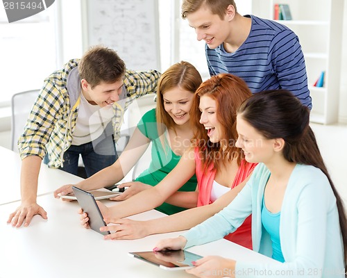 Image of smiling students with tablet pc at school