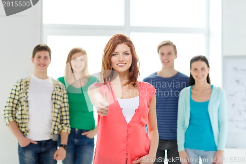 Image of smiling students with teenage girl in front