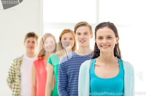 Image of smiling students with teenage girl in front