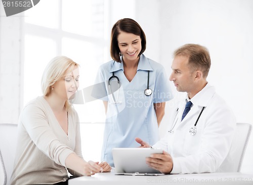 Image of doctor and nurse with patient in hospital