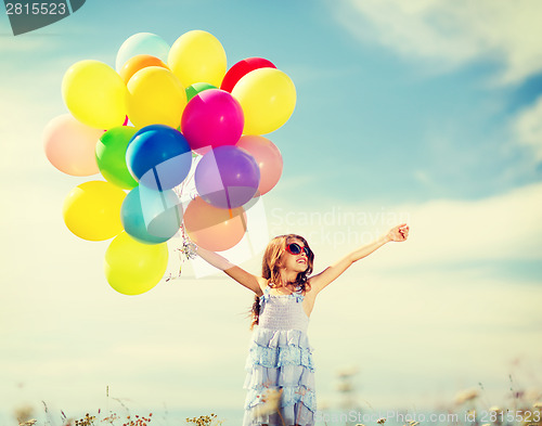 Image of happy girl with colorful balloons