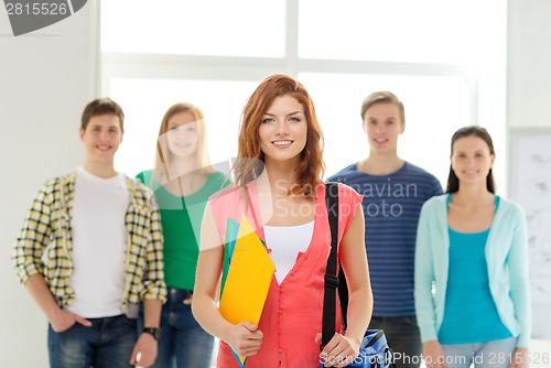 Image of smiling students with teenage girl in front