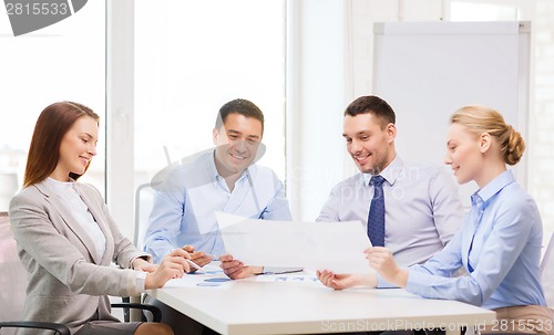 Image of smiling business team having discussion in office