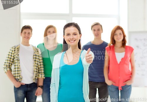 Image of smiling students with teenage girl in front