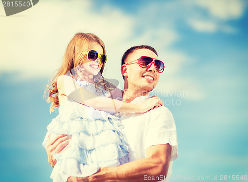 Image of happy father and child in sunglasses over blue sky