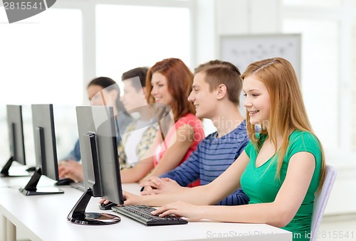 Image of female student with classmates in computer class