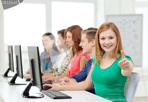 Image of female student with classmates in computer class