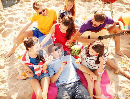 Image of group of friends having fun on the beach