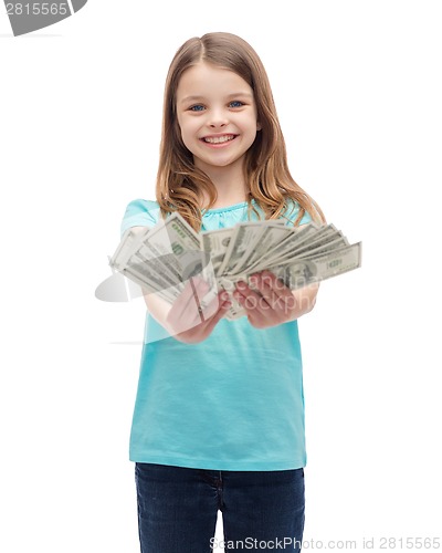 Image of smiling little girl giving dollar cash money