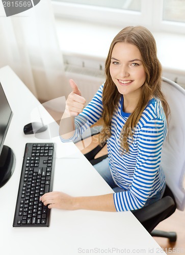 Image of dreaming teenage girl with computer at home