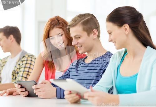 Image of smiling students with tablet pc at school