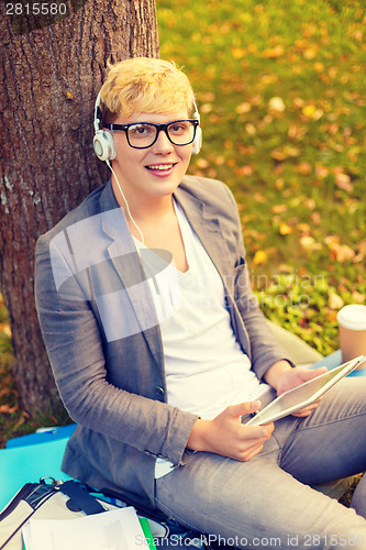 Image of smiling male student in eyeglasses with tablet pc