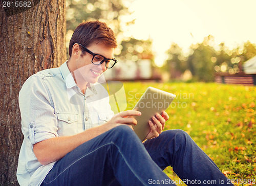 Image of smiling male student in eyeglasses with tablet pc