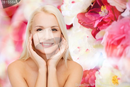 Image of face of beautiful woman touching her face skin