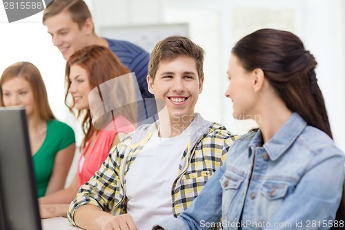 Image of smiling students in computer class at school