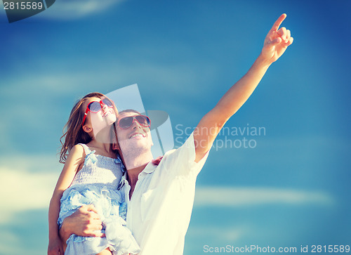 Image of happy father and child in sunglasses over blue sky
