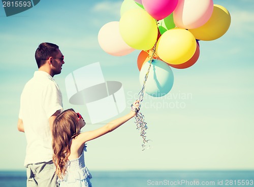 Image of father and daughter with colorful balloons