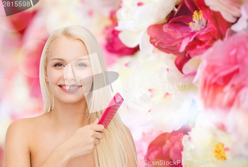 Image of smiling woman with hair brush