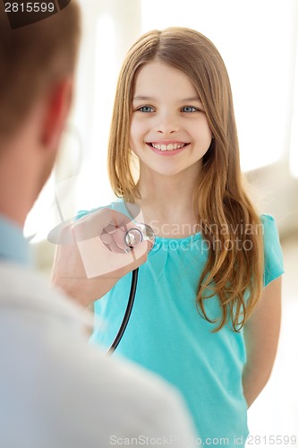 Image of male doctor with stethoscope listening to child