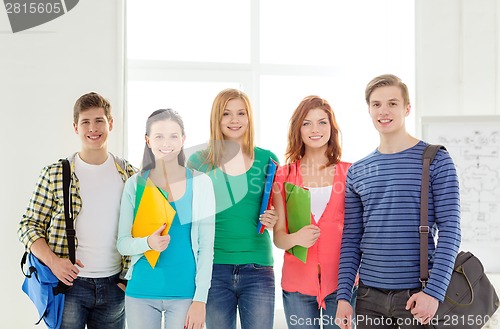 Image of smiling students with bags and folders at school