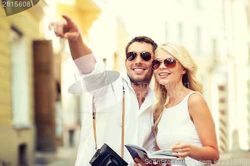 Image of couple with map, camera and travellers guide