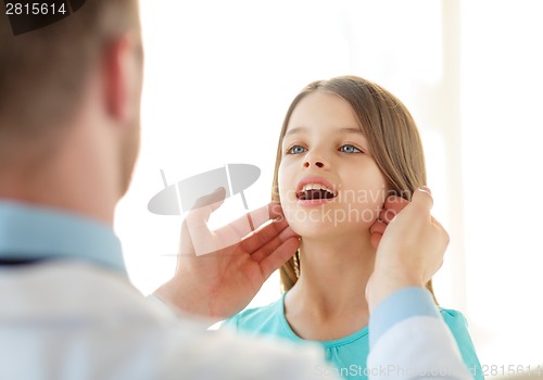 Image of male doctor checks little girl lymph nodes