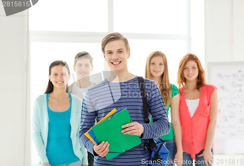 Image of smiling students with teenage boy in front