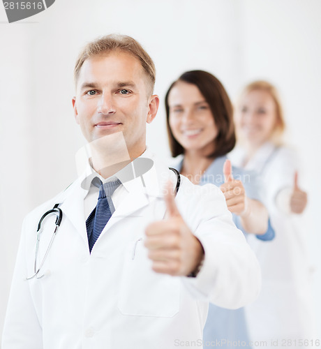 Image of doctor with stethoscope and colleagues