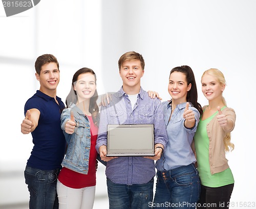 Image of smiling students with laptop computer