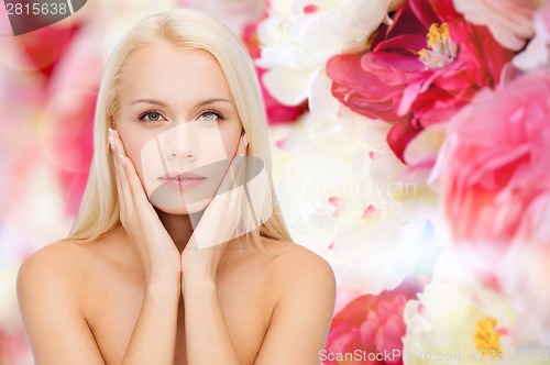 Image of face of beautiful woman touching her face skin