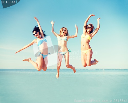 Image of girls jumping on the beach