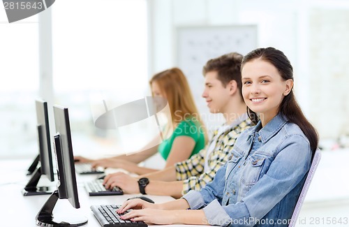 Image of three smiling students in computer class