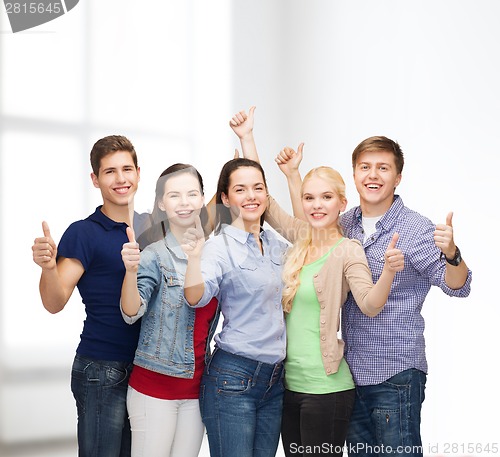 Image of group of smiling students showing thumbs up
