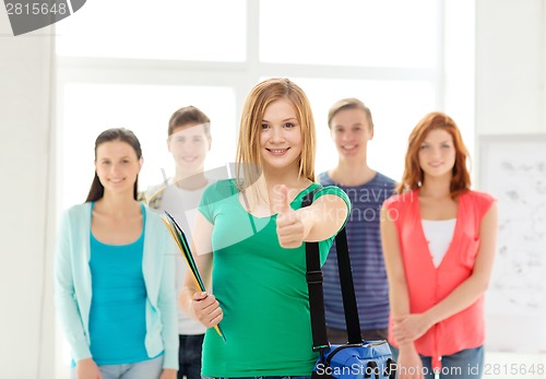 Image of smiling students with teenage girl in front